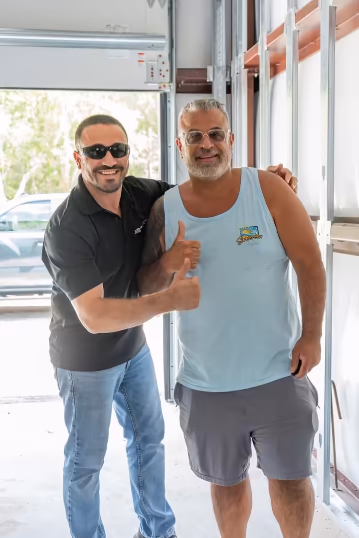 Sunscreen Digital team member with a local business owner in a garage