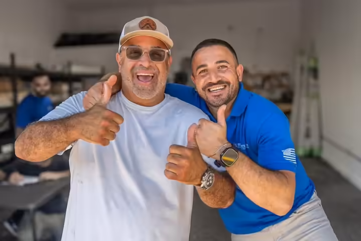 Two local business owners giving a thumbs up
