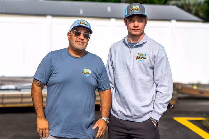 Two members of the Sunscreen Digital team in branded shirts