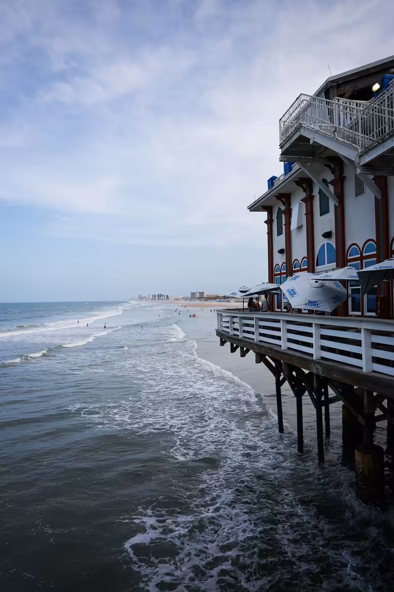 Wooden pier stretching over the beach in Daytona Beach, Florida